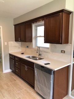 5204 State Road Burbank, IL 60459 - Photo 23 of 30 a kitchen with a sink and a stove