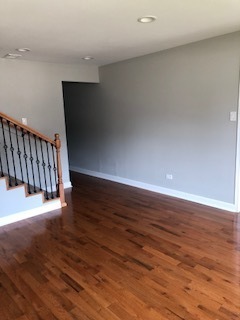 5204 State Road Burbank, IL 60459 - Photo 6 of 30 a view of an empty room with wooden floor and stairs