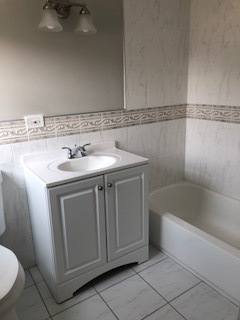 5204 State Road Burbank, IL 60459 - Photo 9 of 30 a bathroom with a sink a toilet and bathtub