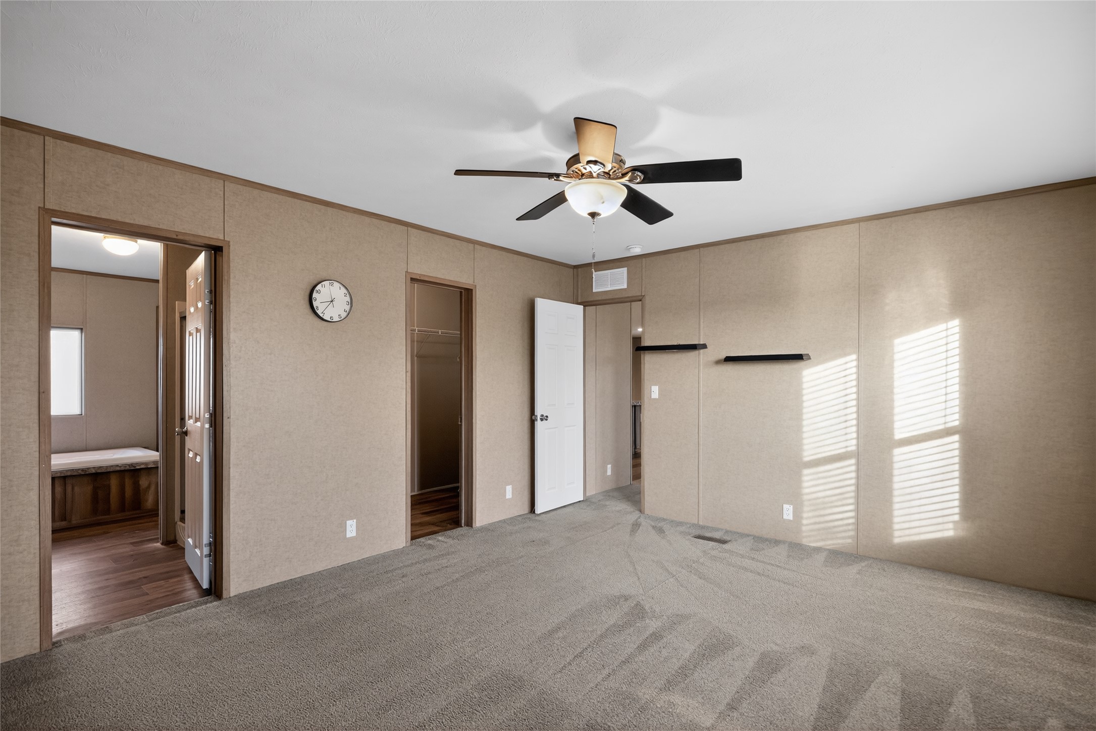 2674 Cotton Gin Road Kyle, TX 78640 - Photo 24 of 30 Unfurnished bedroom featuring carpet, ensuite bathroom, a ceiling fan, a spacious closet, and crown molding