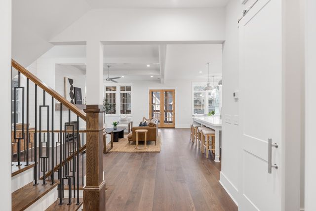 a kitchen with stainless steel appliances granite countertop a kitchen island hardwood floor and a sink