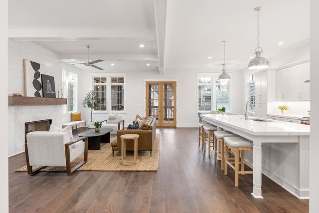 a kitchen with a table chairs stove and wooden floor