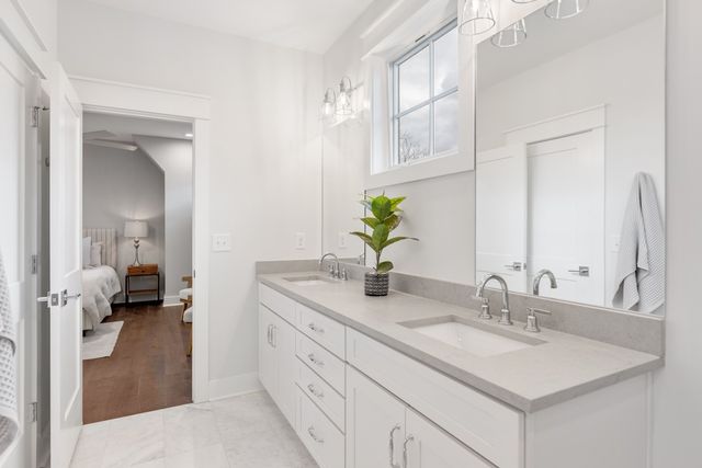 an empty room with wooden floor and white walls