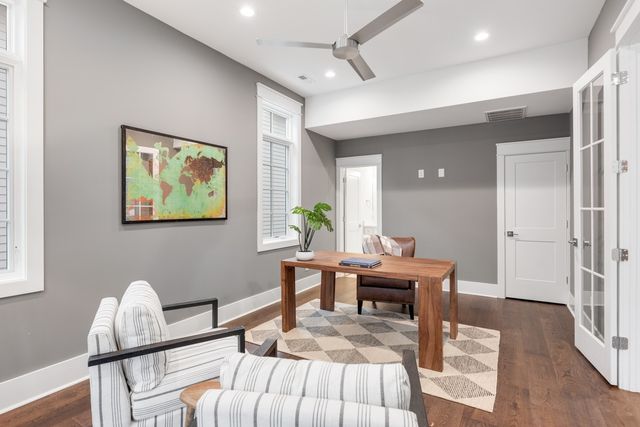 a living room with furniture and a wooden floor