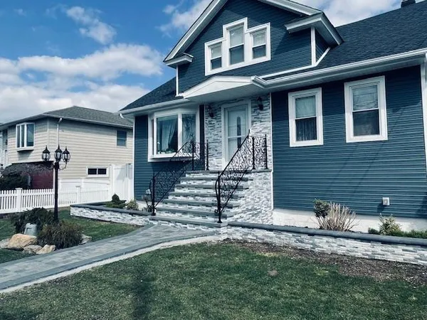 a front view of a house with stairs