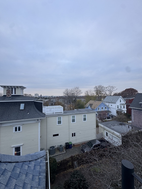 38 Spring Street, Unit 3 Somerville, MA 02143 - Photo 11 of 19 a view of a house with a yard and furniture