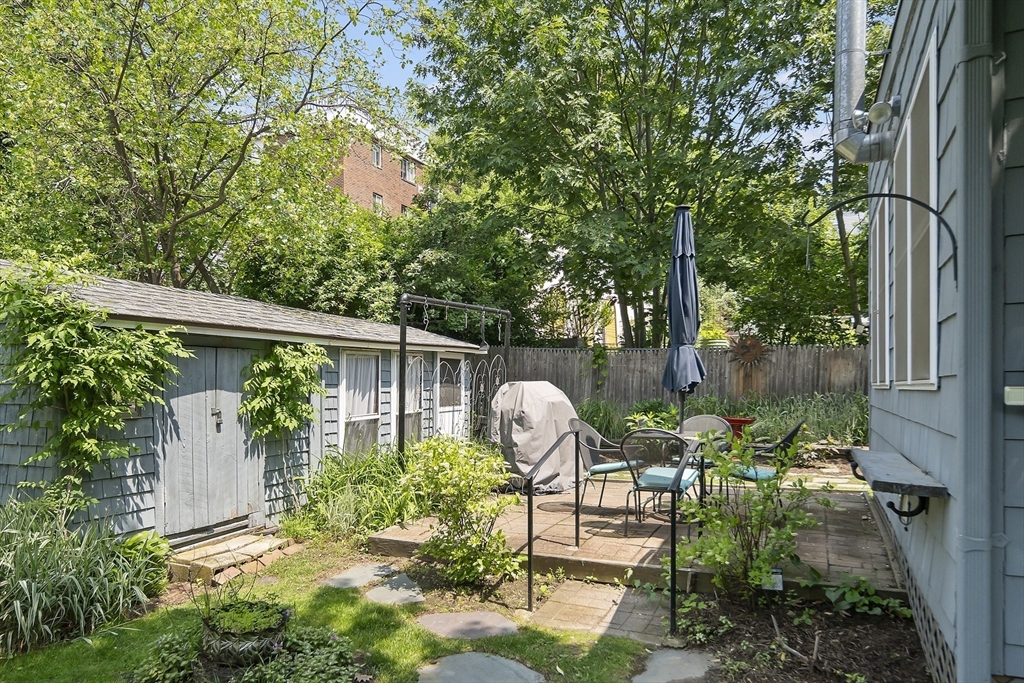 38 Spring Street, Unit 3 Somerville, MA 02143 - Photo 15 of 19 a view of backyard with table and chairs and potted plants
