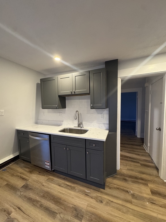 38 Spring Street, Unit 3 Somerville, MA 02143 - Photo 2 of 19 a view of kitchen with granite countertop cabinets and sink