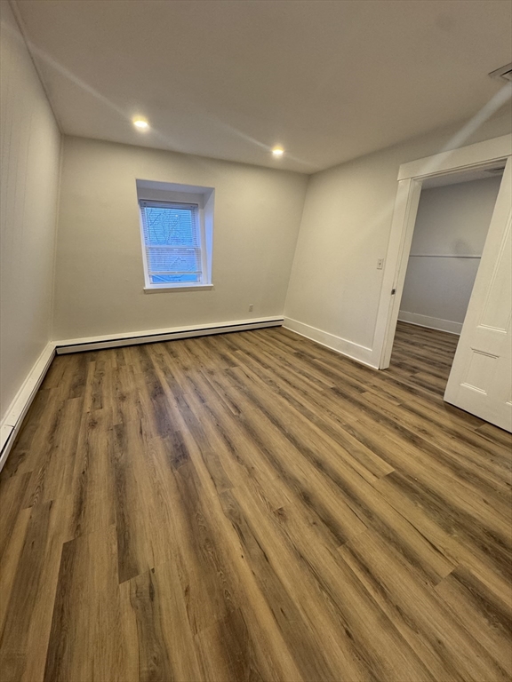 38 Spring Street, Unit 3 Somerville, MA 02143 - Photo 10 of 19 a view of an empty room and wooden floor