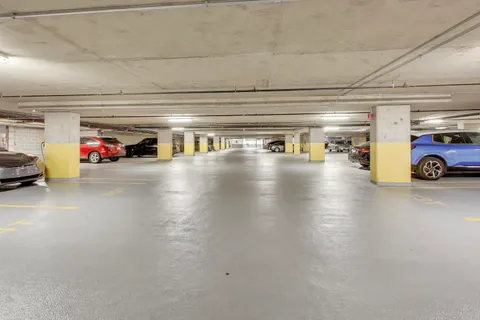 a living room with furniture a chandelier and a large window