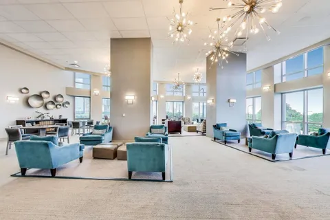 a living room with furniture or chandelier and a large window