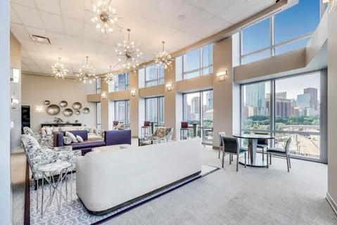 a kitchen with stainless steel appliances granite countertop a refrigerator a sink and a counter top space