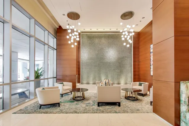 a living room with furniture and a large mirror