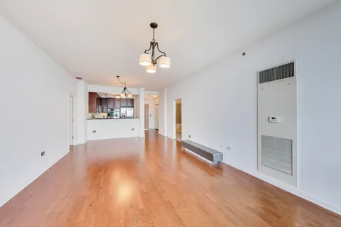 a view of a kitchen with a sink and wooden floor