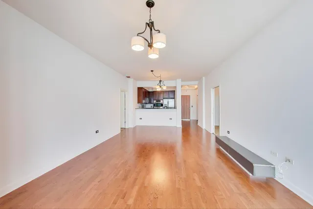 a view of a kitchen with a dishwasher cabinets and wooden floor