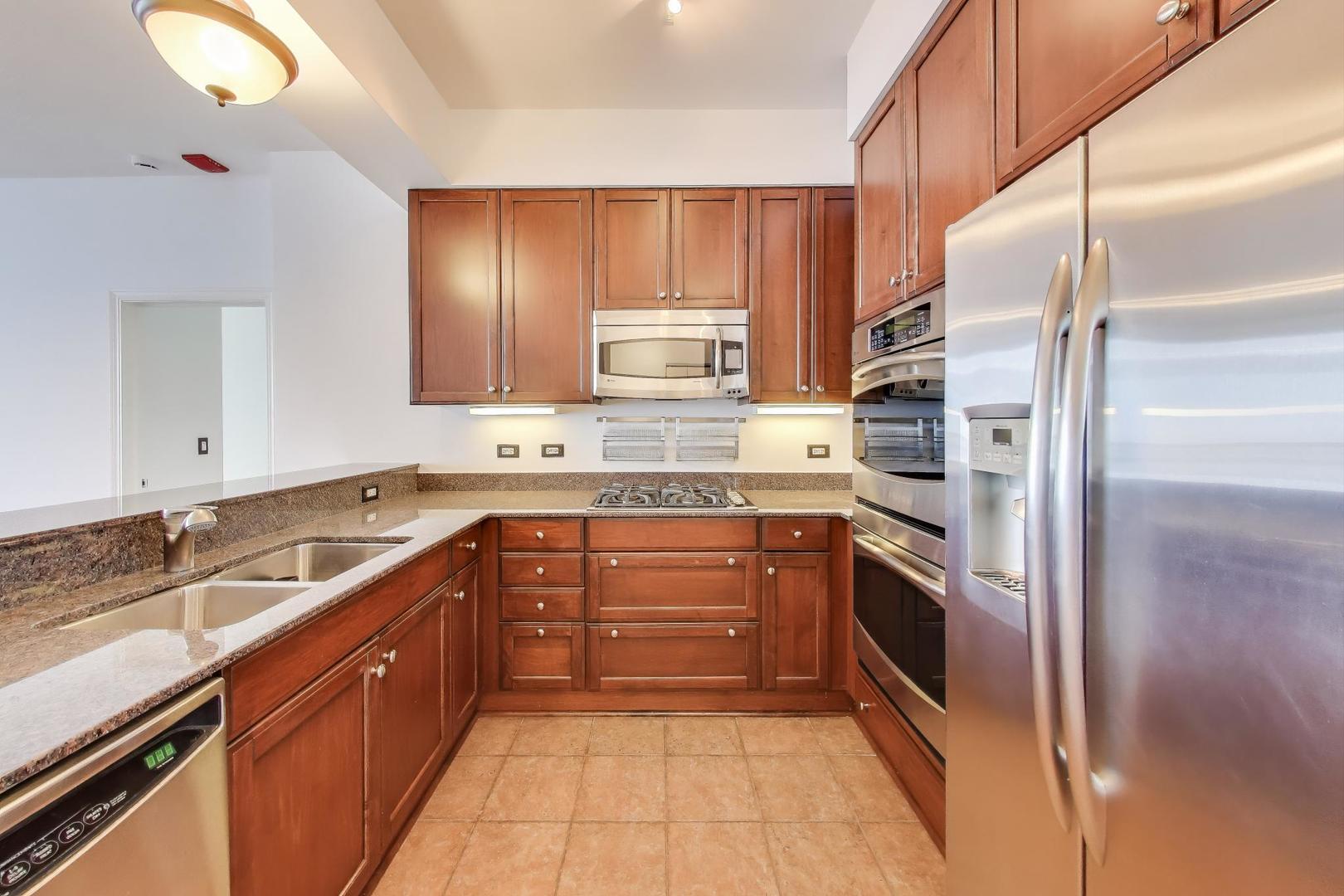 1211 South Prairie Avenue, Unit 2003 Chicago, IL 60605 - Photo 9 of 40 a kitchen with stainless steel appliances granite countertop a sink stove and refrigerator