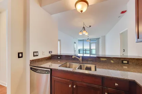 a kitchen that has a sink cabinets and window