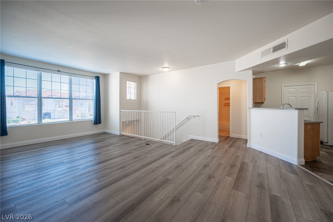 8555 West Russell Road, Unit 2062 Las Vegas, NV 89113 - Photo 7 of 35 A versatile living space with light wood-look flooring and abundant natural illumination awaits.