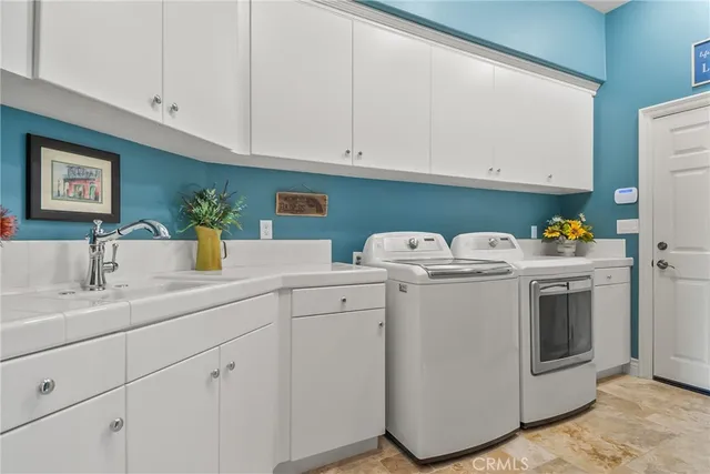 a living room with fireplace furniture and a large window