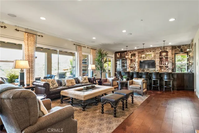 a kitchen with stainless steel appliances granite countertop a stove top oven a sink dishwasher and cabinets with wooden floor