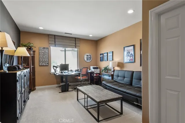 a view of a city from a balcony with dining table & chairs