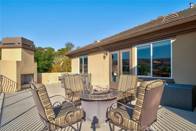 a view of a patio with a table and chairs and potted plants