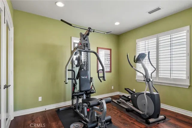 a view of a house with a big yard and a large tree