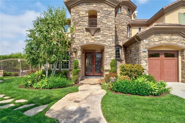 a front view of a house with garden