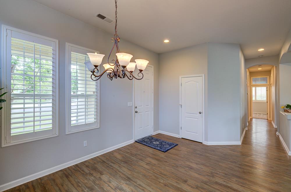 3235 Rall Avenue Clovis, CA 93619 - Photo 9 of 33 a view of a room with wooden floor and windows
