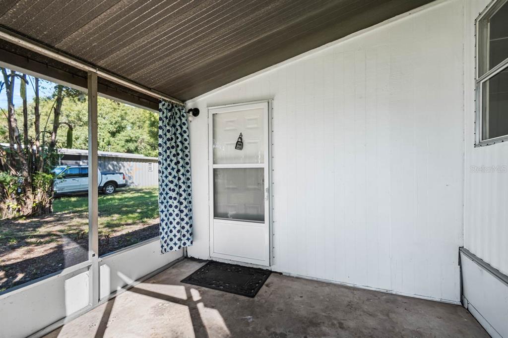 105 Domino Drive North Ruskin, FL 33570 - Photo 11 of 12 a porch with a table and chairs