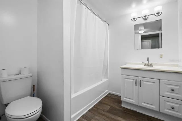 a bathroom with a sink a toilet a vanity and mirror