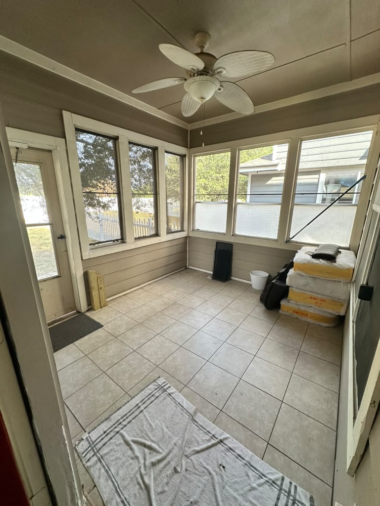 1981 Prairie Rock Way Round Rock, TX 78664 - Photo 19 of 22 Tiled flooring and wood paneled walls anchor this sunlit enclosed porch.