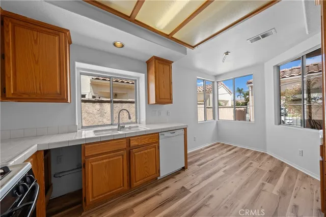 a kitchen with a sink stove and cabinets