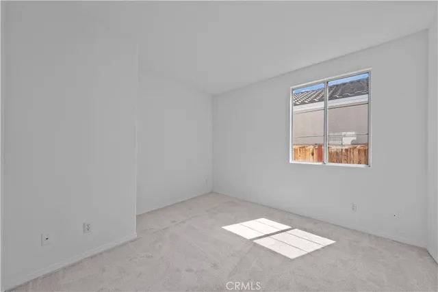 a front view of a house with a garden and mountain view