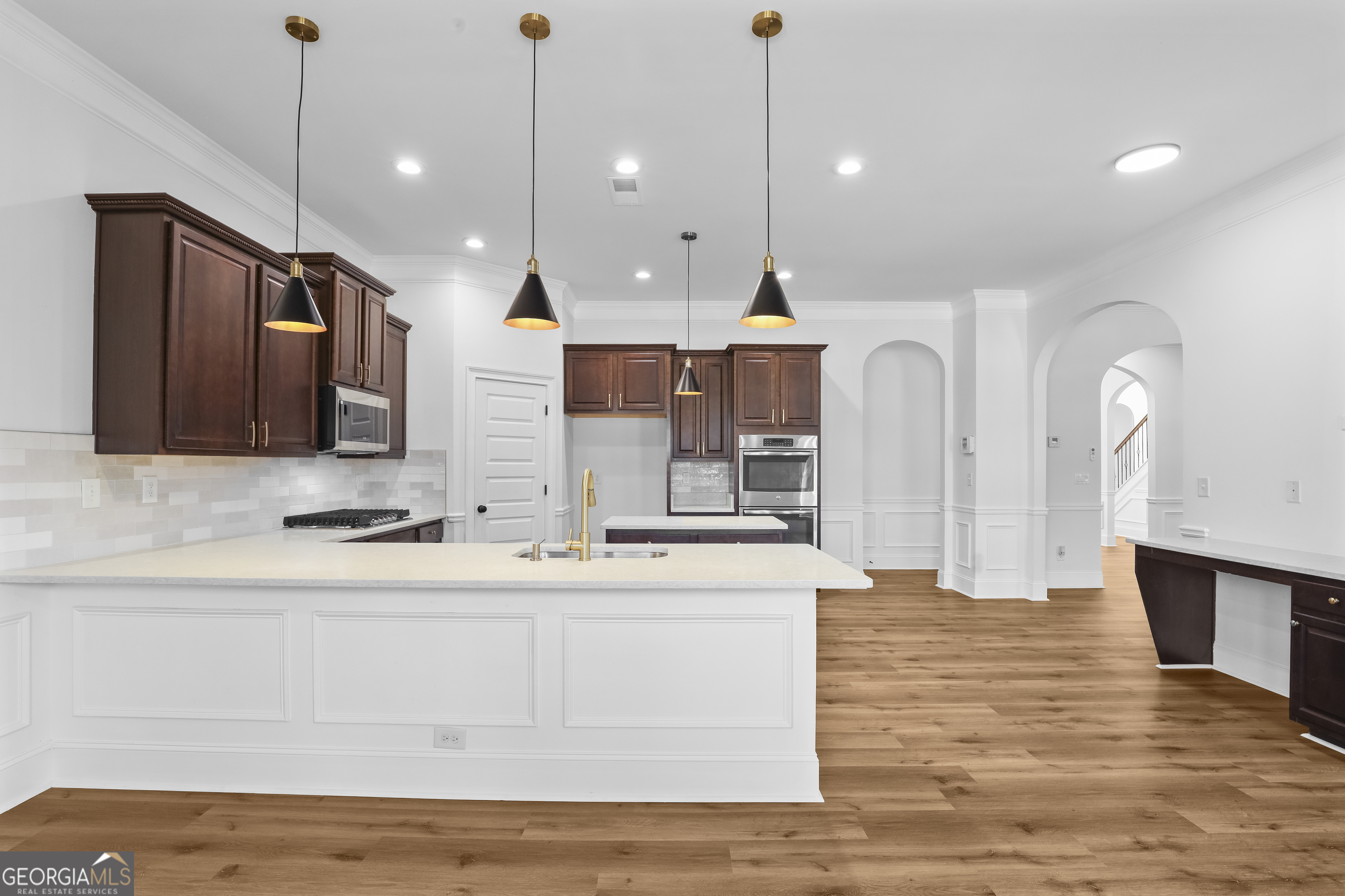 200 Snow Bird Drive Hampton, GA 30228 - Photo 15 of 55 a large white kitchen with a large island oven a sink stainless steel appliances and cabinets