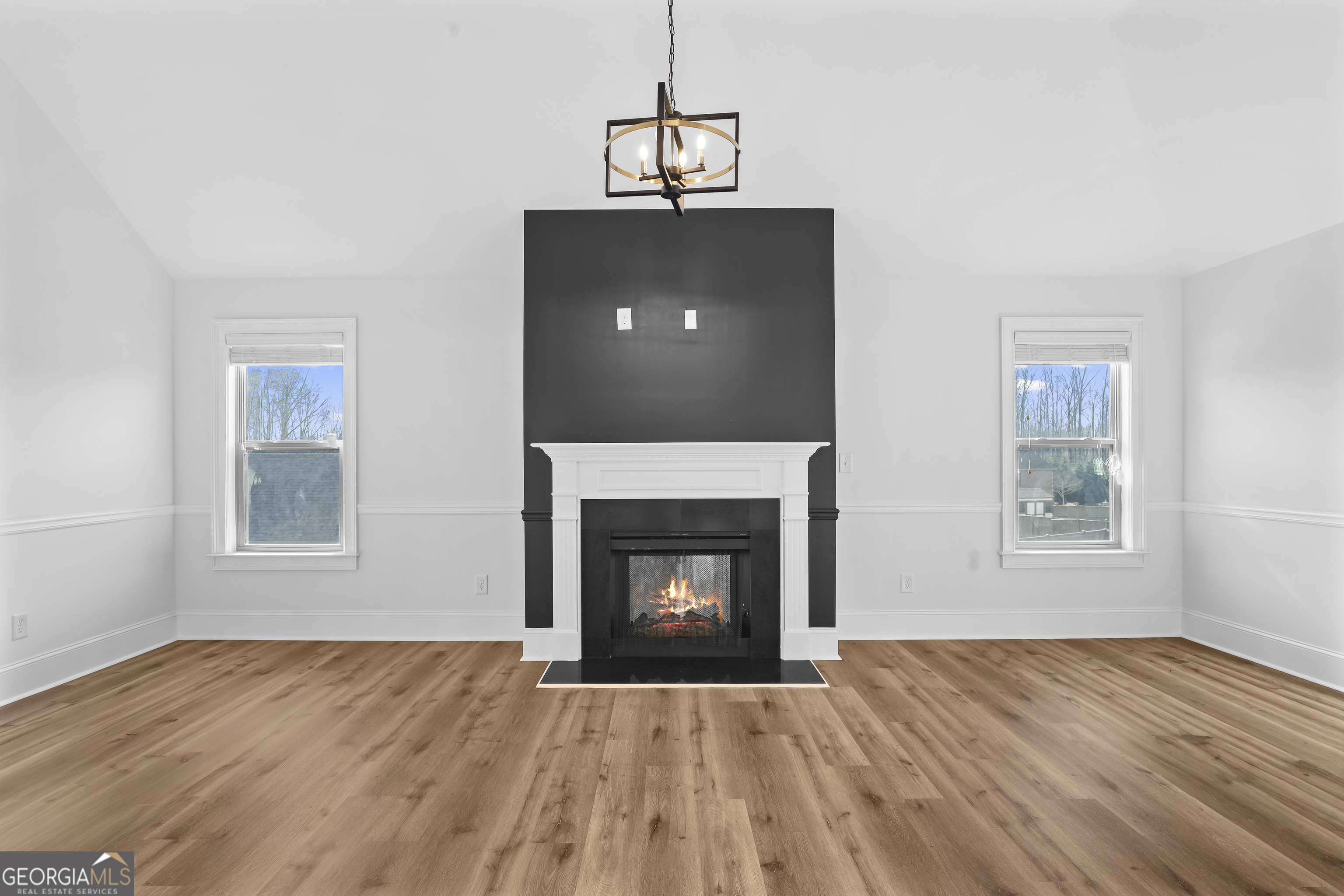 200 Snow Bird Drive Hampton, GA 30228 - Photo 26 of 55 a view of an empty room with wooden floor fireplace and a window
