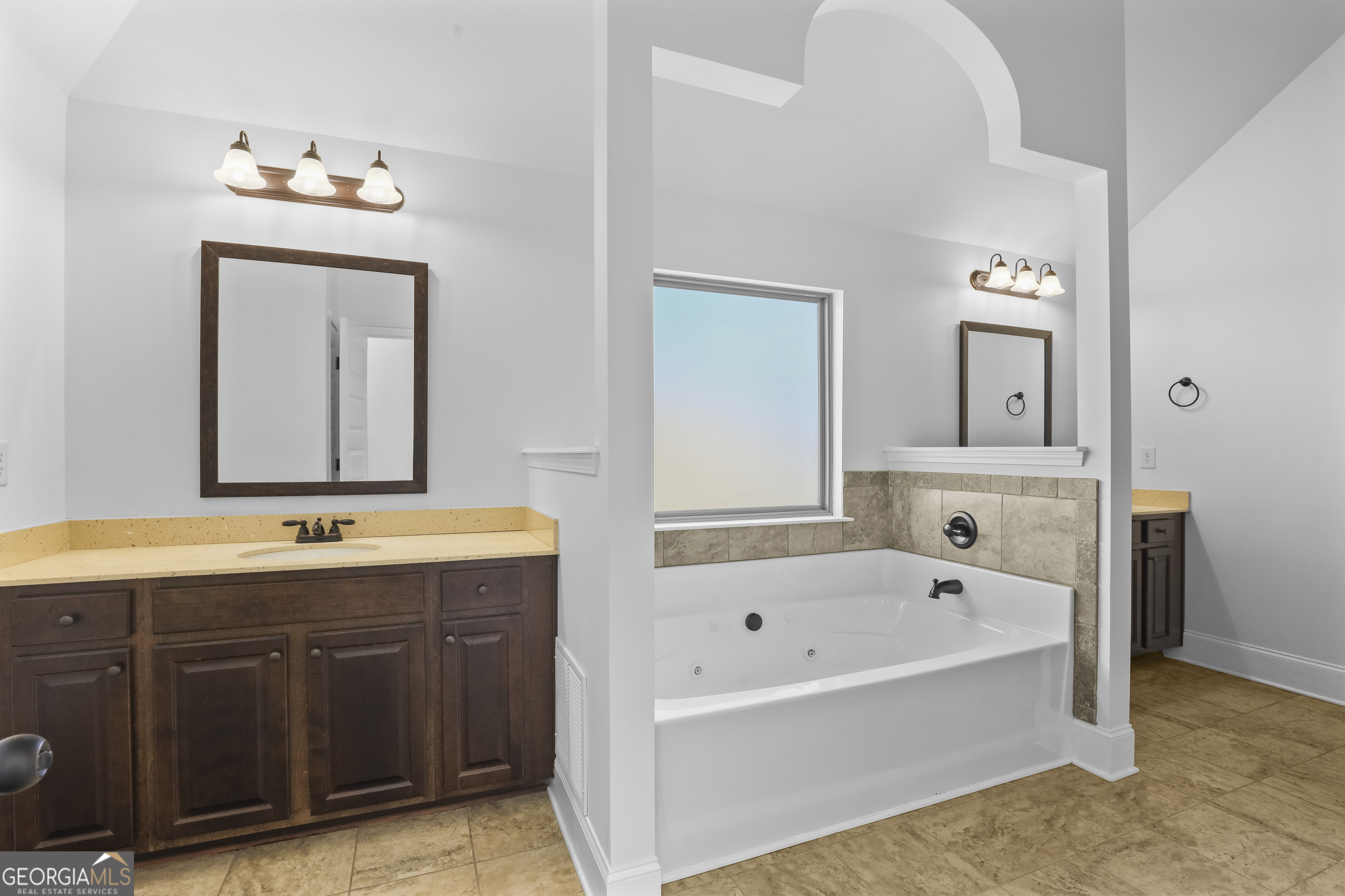 200 Snow Bird Drive Hampton, GA 30228 - Photo 29 of 55 a bathroom with a tub sink and mirror