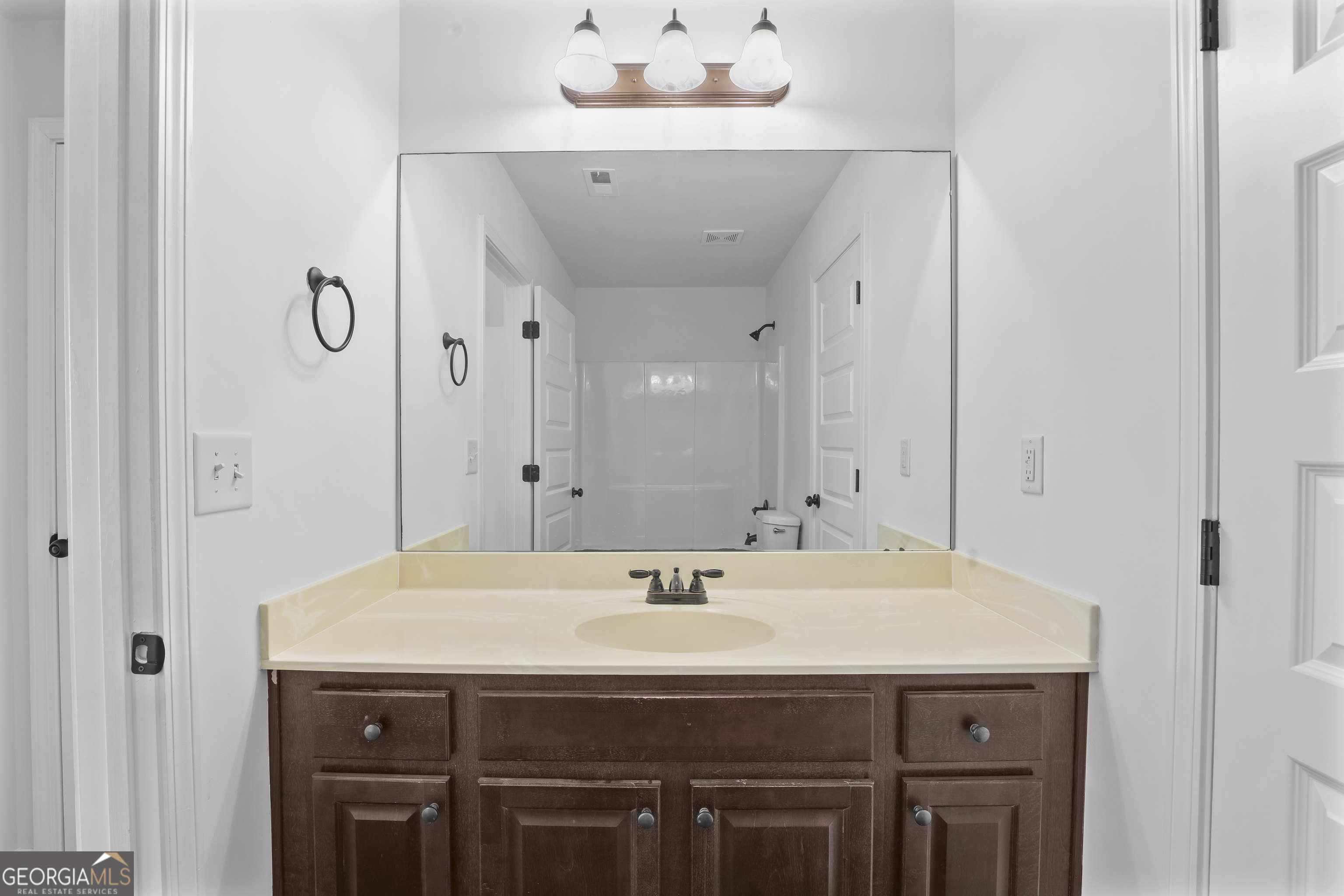200 Snow Bird Drive Hampton, GA 30228 - Photo 37 of 55 a bathroom with a sink and a mirror