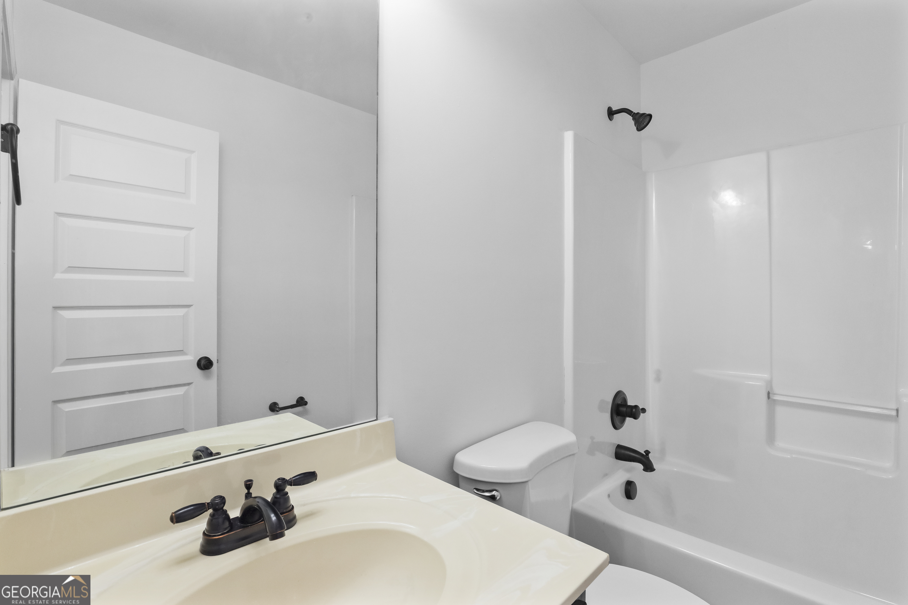 200 Snow Bird Drive Hampton, GA 30228 - Photo 40 of 55 a bathroom with a sink a toilet and shower