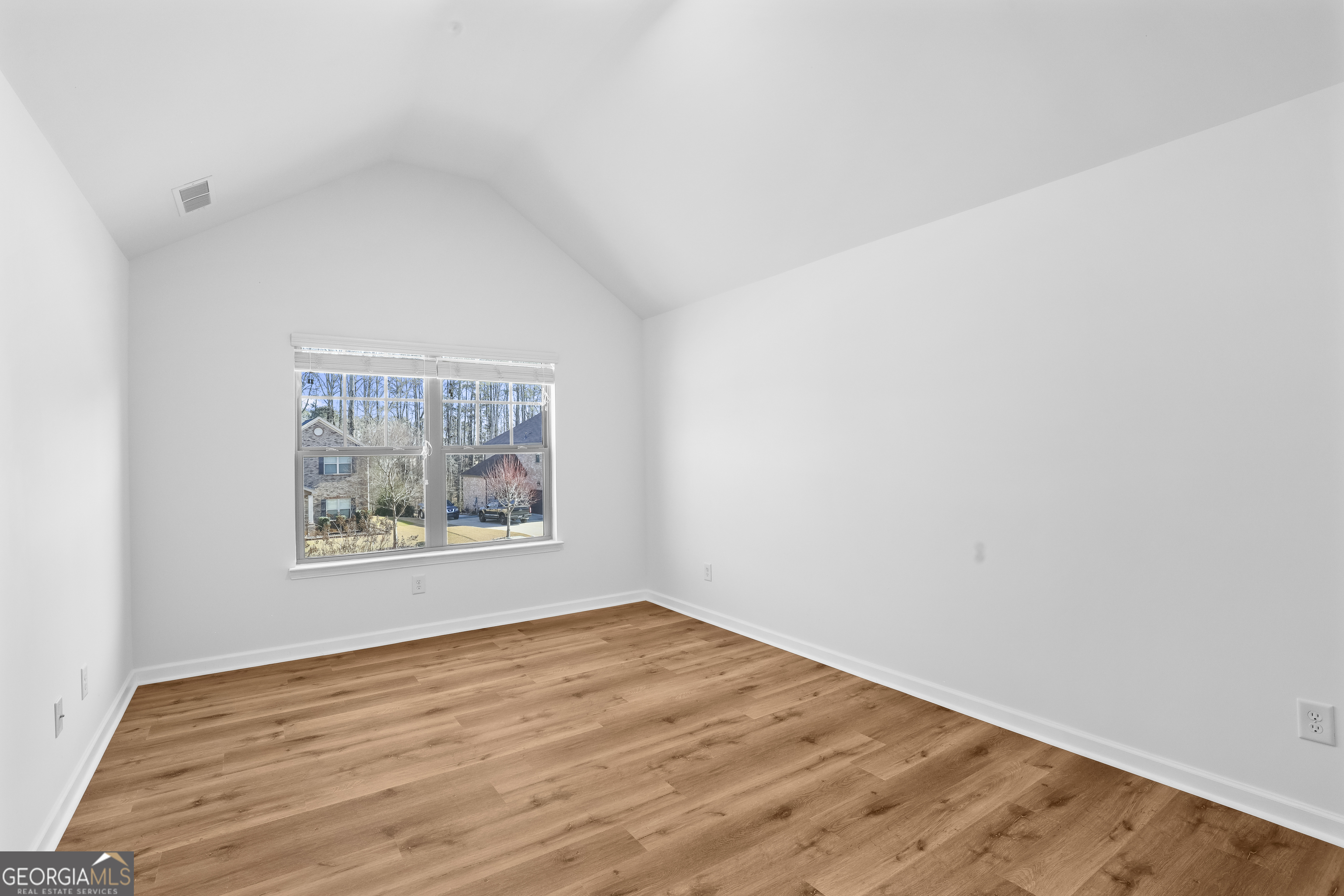 200 Snow Bird Drive Hampton, GA 30228 - Photo 41 of 55 a view of an empty room with wooden floor and a window