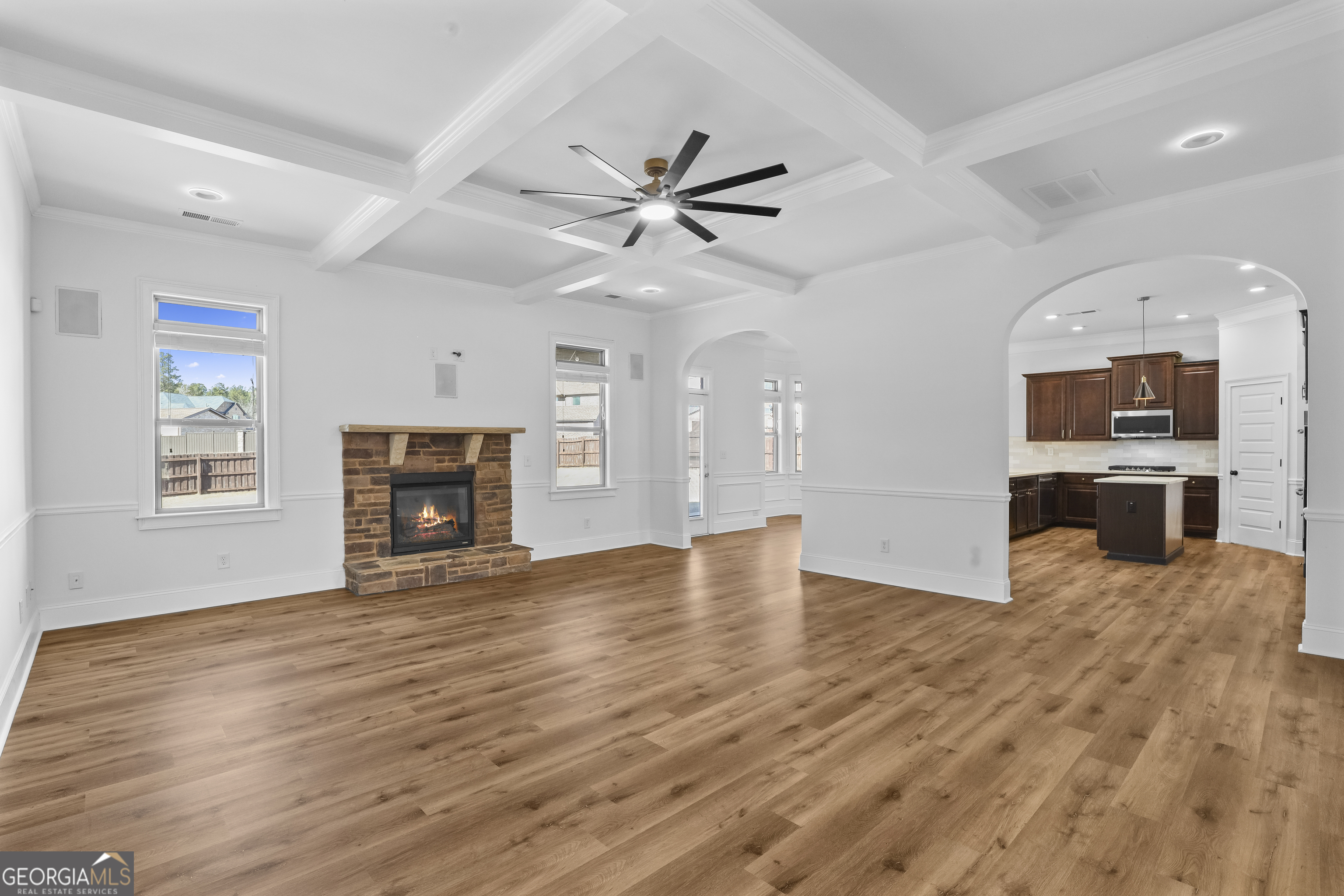 200 Snow Bird Drive Hampton, GA 30228 - Photo 9 of 55 an empty room with wooden floor fireplace and a window