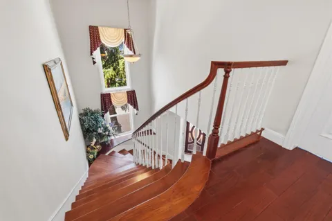 a view of entryway and hall with wooden floor