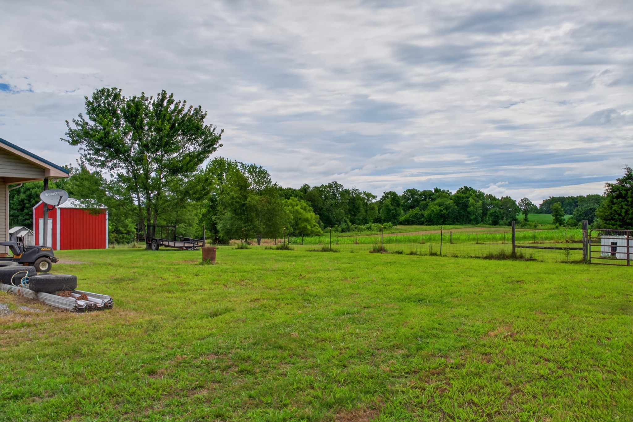618 Lear Road Portland, TN 37148 - Photo 10 of 29 a backyard of a house with lots of green space and trampoline