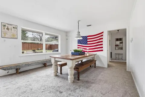 a room with pool table and windows