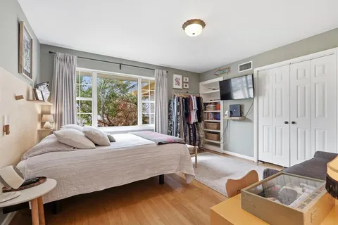 a bedroom with a bed and a window