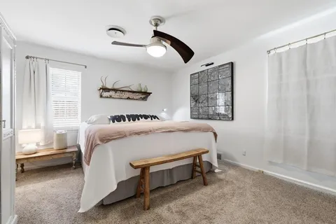 a bedroom with a bed and a television