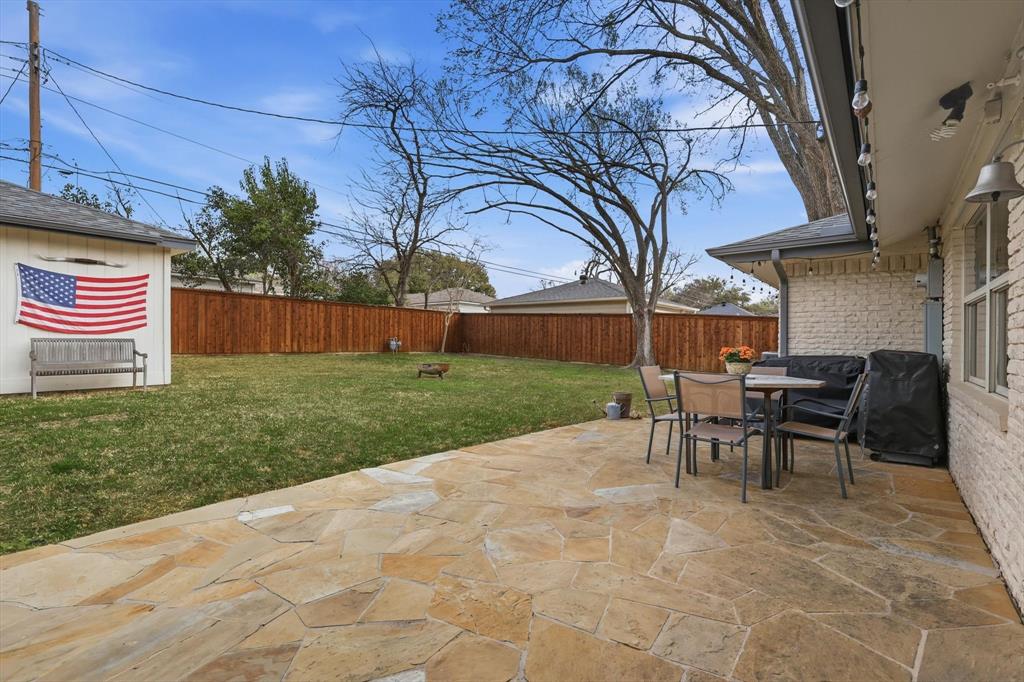 10029 Shadyview Drive Dallas, TX 75238 - Photo 22 of 30 a view of a backyard with table and chairs and a barbeque