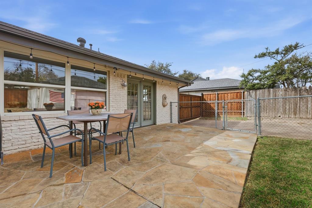 10029 Shadyview Drive Dallas, TX 75238 - Photo 24 of 30 a backyard of a house with table and chairs
