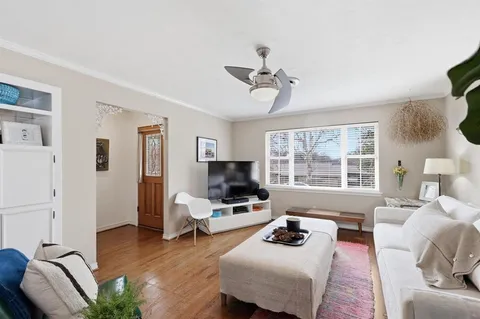 a living room with furniture fireplace and a window