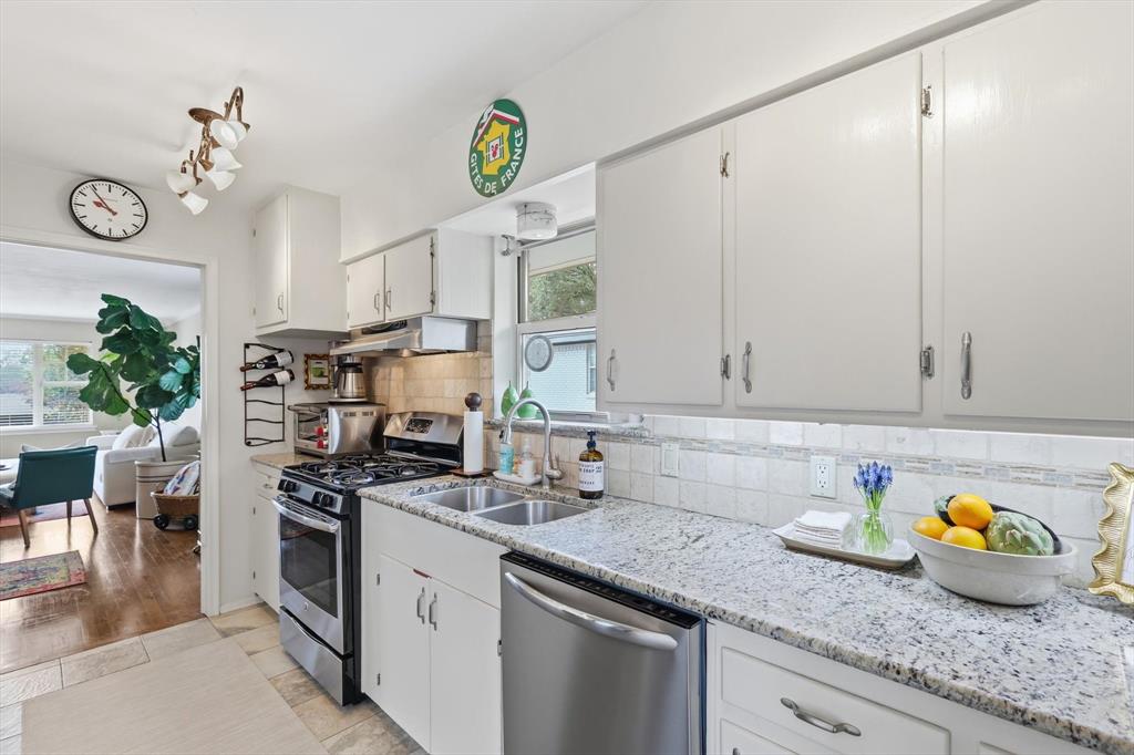 10029 Shadyview Drive Dallas, TX 75238 - Photo 9 of 30 a kitchen with stainless steel appliances granite countertop a sink a stove and cabinets